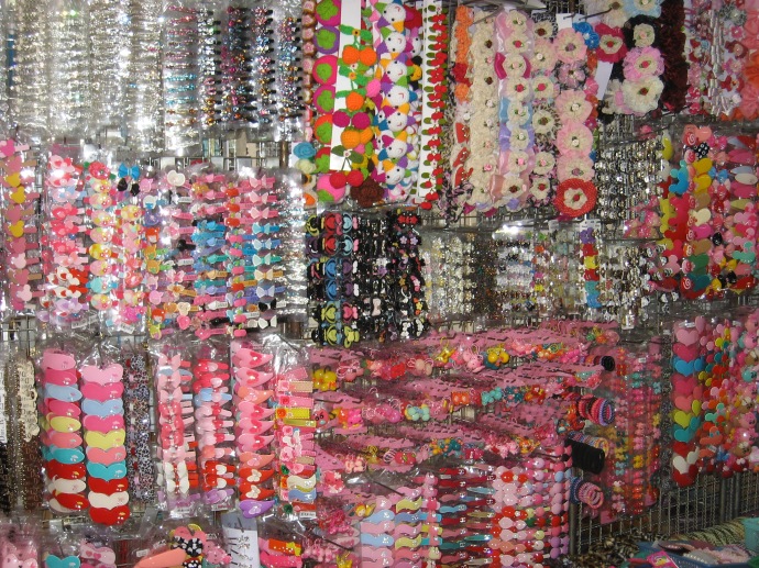 Girl barrettes covering the wall of a store in one of the many Bangkok markets