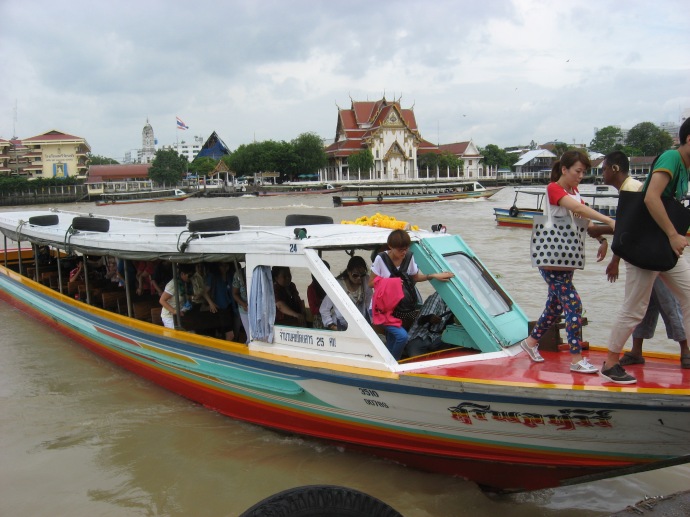 Tourist group boats on river thru Bangkok