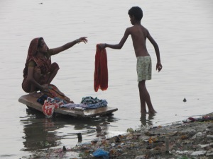 Washing clothes by hand in the river